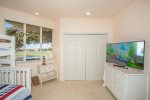 The fourth bedroom offers ample space and a flat screen TV